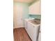 Laundry room with white cabinets, tile floor, and modern washer and dryer at 16805 Sunrise Vista Dr, Clermont, FL 34714