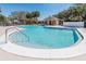 Community pool featuring clear blue water, a white concrete deck, and a nearby cabana for residents' enjoyment at 16805 Sunrise Vista Dr, Clermont, FL 34714