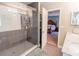 Bathroom boasts glass shower with gray tile leading to the main bedroom at 16805 Sunrise Vista Dr, Clermont, FL 34714