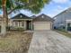 Charming single-story home featuring a two-car garage and well-maintained front yard at 1748 Ribbon Falls Pkwy, Orlando, FL 32824