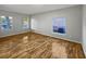 Light-filled living room featuring beautiful hardwood floors and bright neutral walls at 1748 Ribbon Falls Pkwy, Orlando, FL 32824