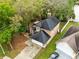 Aerial view of a two-story house with a car parked in the driveway with a lush green yard and an adjacent lake at 217 Oak Park Pl, Casselberry, FL 32707