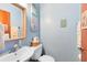 Bathroom with wood-framed mirror, white sink, and toilet at 217 Oak Park Pl, Casselberry, FL 32707