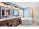 Bright bathroom features dual sinks, soaking tub, and shower at 217 Oak Park Pl, Casselberry, FL 32707