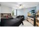 Cozy bedroom with a black quilt, TV, and relaxing seating at 217 Oak Park Pl, Casselberry, FL 32707