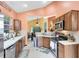 Well-lit kitchen with stainless steel appliances, wooden cabinets, and tile backsplash at 217 Oak Park Pl, Casselberry, FL 32707