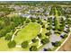 Aerial view of a neighborhood with a park and lush trees around the homes at 2224 Romanum Dr, Winter Garden, FL 34787