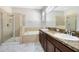 Bathroom features double sinks, granite countertops, a bathtub, and glass enclosed shower at 2224 Romanum Dr, Winter Garden, FL 34787