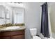 Bathroom features a single vanity and a shower with a blue shower curtain at 2224 Romanum Dr, Winter Garden, FL 34787