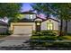 Charming two-story home features a well-manicured lawn, stone accents, and a two-car garage at 2224 Romanum Dr, Winter Garden, FL 34787