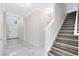 Bright foyer with elegant marble floors and wooden stairs leading to the upper level at 2224 Romanum Dr, Winter Garden, FL 34787