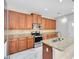 Spacious kitchen featuring stainless steel appliances, granite countertops, and wooden cabinets at 2224 Romanum Dr, Winter Garden, FL 34787