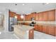 Spacious kitchen featuring stainless steel appliances, granite countertops, and wooden cabinets at 2224 Romanum Dr, Winter Garden, FL 34787