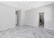 Spacious main bedroom with marble floors, neutral paint and ensuite bathroom at 2224 Romanum Dr, Winter Garden, FL 34787