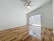 Bright bedroom with high ceilings, wood-look floors, and sliding glass door to patio at 2253 Atrium Cir, Orlando, FL 32808