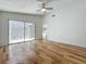 Bright bedroom with wood look floors and sliding glass door leading to a patio at 2253 Atrium Cir, Orlando, FL 32808
