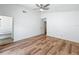 A bright bedroom has wood-look floors, ceiling fan, closet, and attached vanity area at 2253 Atrium Cir, Orlando, FL 32808