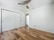 Bright bedroom features wood floors, ceiling fan, and closet with double doors at 2253 Atrium Cir, Orlando, FL 32808