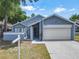 Charming single-story home featuring a well-maintained lawn and attached two-car garage at 2253 Atrium Cir, Orlando, FL 32808