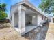 Back exterior view showcasing the covered patio, siding, and backyard of the home at 2253 Atrium Cir, Orlando, FL 32808