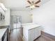 Open kitchen boasts modern appliances, island, wood floors, and sliding door to patio at 2253 Atrium Cir, Orlando, FL 32808
