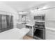Open kitchen boasts stainless steel appliances, and eat-in counter at 2253 Atrium Cir, Orlando, FL 32808