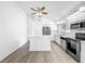 Well-lit open kitchen with stainless steel appliances, white cabinets, and eat-in counter at 2253 Atrium Cir, Orlando, FL 32808