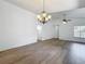 Spacious living room with wood floors, chandelier, and ceiling fan at 2253 Atrium Cir, Orlando, FL 32808