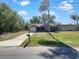 Inviting single-Gathering home with well-kept lawn, palm tree, and driveway at 233 Chadworth Dr, Kissimmee, FL 34758