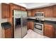 Well-equipped kitchen featuring stainless steel appliances and wood cabinetry at 233 Chadworth Dr, Kissimmee, FL 34758