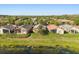 Aerial view of backyards along the lake, featuring screened enclosures and lush lawns at 237 Rialto Rd, Kissimmee, FL 34759