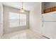 Bright dining area with a window, overhead light fixture, and a white refrigerator at 237 Rialto Rd, Kissimmee, FL 34759