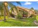 Exterior view of the house showing the screened lanai and green landscaping at 237 Rialto Rd, Kissimmee, FL 34759