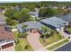 Aerial view of a single-Gathering home featuring a brick driveway, manicured landscaping and a gray roof at 2480 Northumbria Dr, Sanford, FL 32771