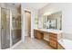 Well-lit bathroom with a glass shower, vanity, tile flooring, and large mirrors at 2480 Northumbria Dr, Sanford, FL 32771