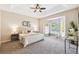 Spacious main bedroom featuring neutral tones, tray ceiling, and bay window sitting area at 2480 Northumbria Dr, Sanford, FL 32771