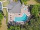 Aerial shot of the community pool with a hot tub, lounge seating, and dining tables available for residents at 2480 Northumbria Dr, Sanford, FL 32771