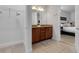 Well-lit bathroom featuring granite countertops, dual sinks and closet space leading into bedroom at 321 Pendant Ct, Kissimmee, FL 34747