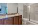 Bathroom vanity with granite countertop, and a glass-enclosed shower at 321 Pendant Ct, Kissimmee, FL 34747