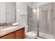 Well-lit bathroom featuring a glass shower door, granite countertops, and ample counter space at 321 Pendant Ct, Kissimmee, FL 34747