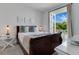 Bright bedroom featuring a dark wood sleigh bed and a sunny outdoor balcony at 321 Pendant Ct, Kissimmee, FL 34747