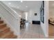 Foyer with stairs leading to the upper level with white walls and tiled floors throughout at 321 Pendant Ct, Kissimmee, FL 34747