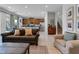 Open concept living room with a couch and tiled floors adjacent to a kitchen with wood cabinets at 321 Pendant Ct, Kissimmee, FL 34747