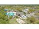 Overhead view of pool and volleyball court plus lounge area with trees surrounding it at 3780 Woodhurst Ct, Oviedo, FL 32766