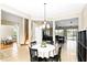 Dining room with a round table, a chandelier, and views into the living room and kitchen at 3780 Woodhurst Ct, Oviedo, FL 32766