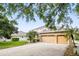 Beautiful two-story house with a three-car garage, a brick paved drive and mature landscaping at 3780 Woodhurst Ct, Oviedo, FL 32766