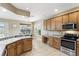 This kitchen offers great natural light, wood cabinetry, stainless appliances, lots of counterspace, and seamless transition into dining area at 3780 Woodhurst Ct, Oviedo, FL 32766