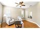 Cozy living room with hardwood floors, neutral paint, lots of natural light, and a ceiling fan at 3780 Woodhurst Ct, Oviedo, FL 32766