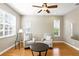 Cozy living room with hardwood floors, neutral paint, lots of natural light, and a ceiling fan at 3780 Woodhurst Ct, Oviedo, FL 32766