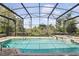 Backyard swimming pool with spa in screened lanai offers a private tropical oasis at 3780 Woodhurst Ct, Oviedo, FL 32766